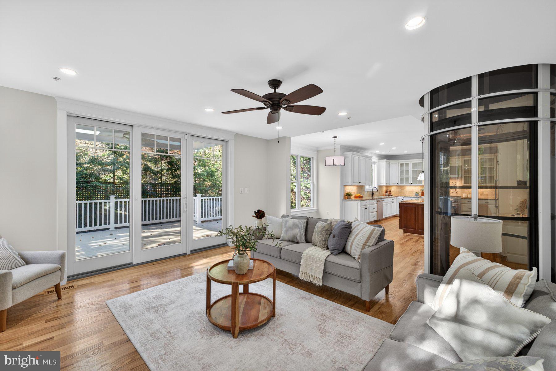 5011 Rugby Avenue Bethesda, MD 20814 - Photo 20 of 65 a living room with furniture and a large window with wooden floor