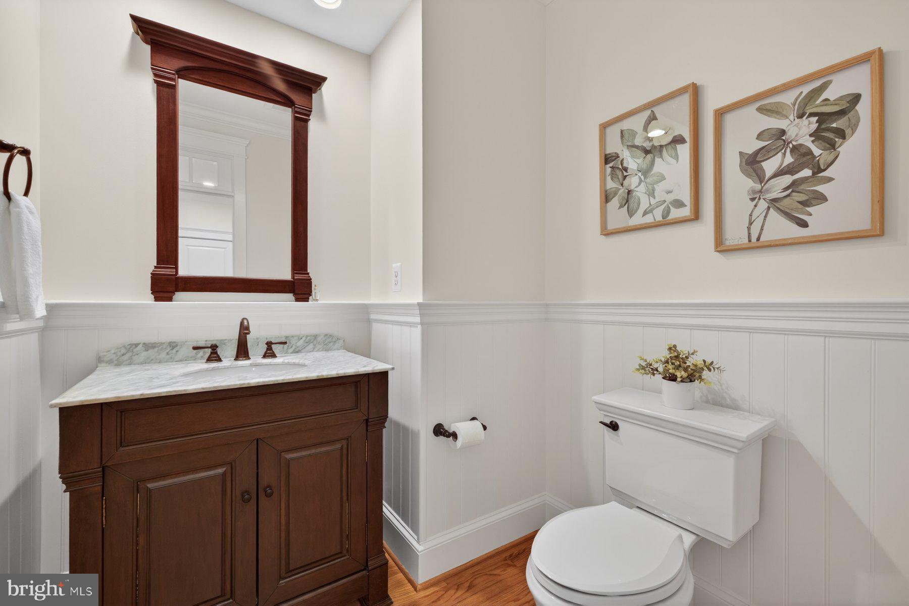 5011 Rugby Avenue Bethesda, MD 20814 - Photo 22 of 65 a bathroom with a toilet a sink and mirror