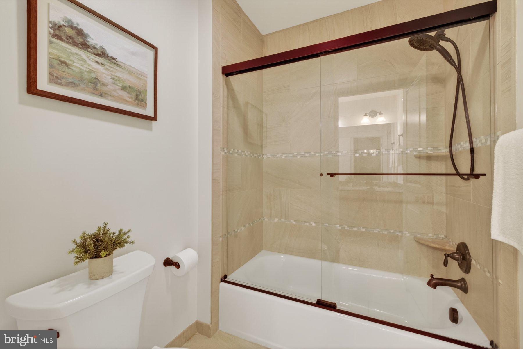 5011 Rugby Avenue Bethesda, MD 20814 - Photo 27 of 65 a bathroom with a bathtub and a shower