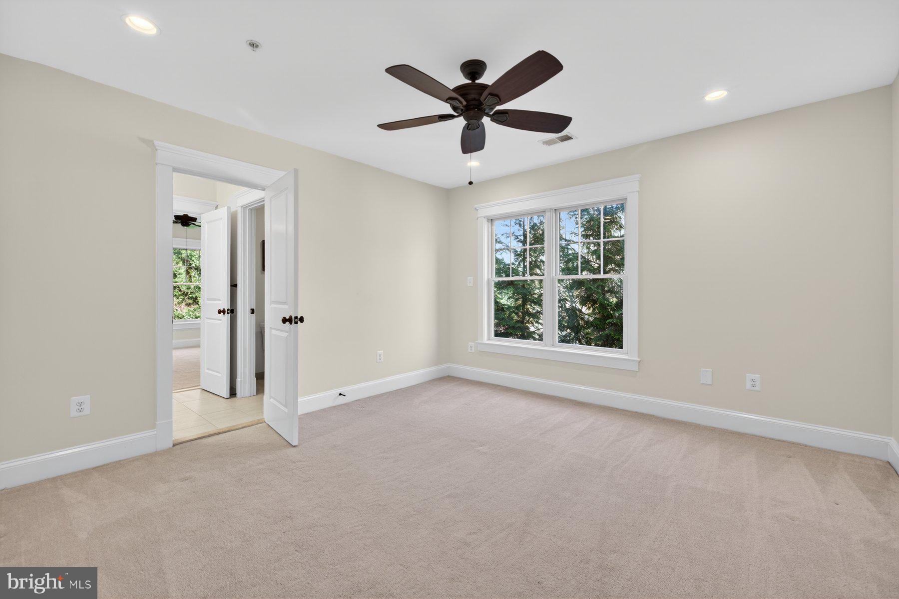 5011 Rugby Avenue Bethesda, MD 20814 - Photo 28 of 65 an empty room with ceiling fan and windows