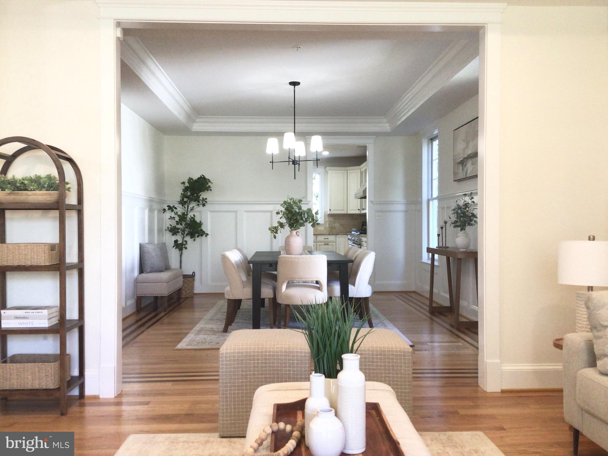 5011 Rugby Avenue Bethesda, MD 20814 - Photo 3 of 65 a dining room with furniture a chandelier and wooden floor