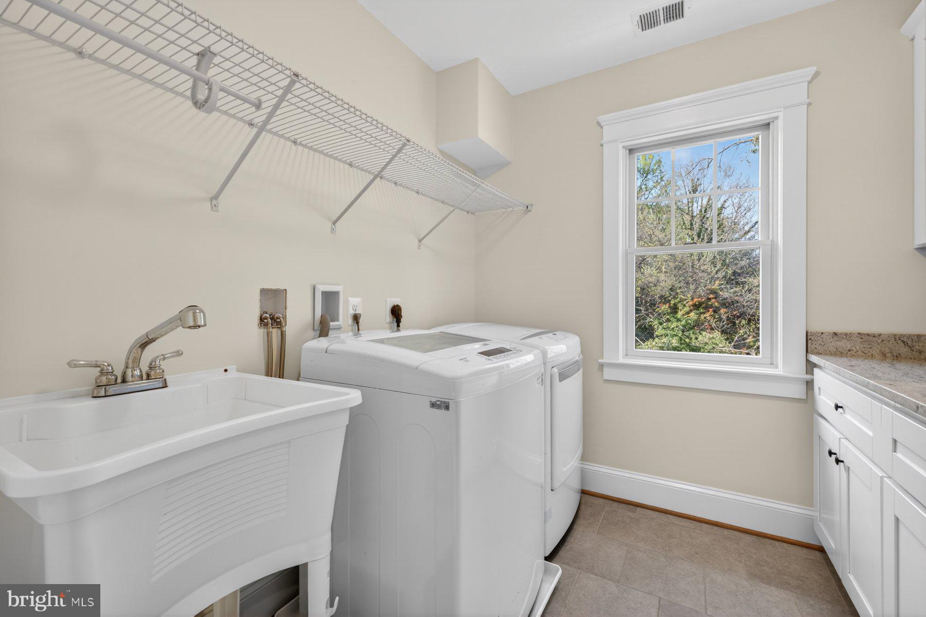 5011 Rugby Avenue Bethesda, MD 20814 - Photo 32 of 65 a utility room with dryer and washer