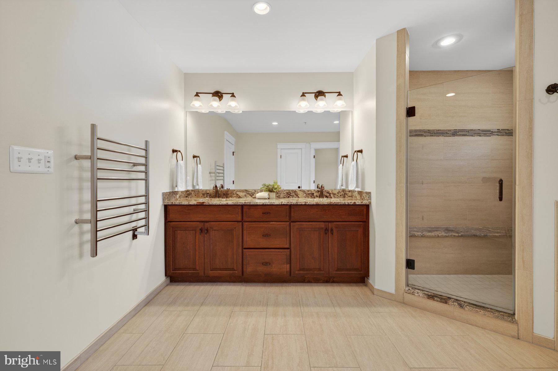 5011 Rugby Avenue Bethesda, MD 20814 - Photo 39 of 65 a bathroom with a granite countertop sink mirror and shower