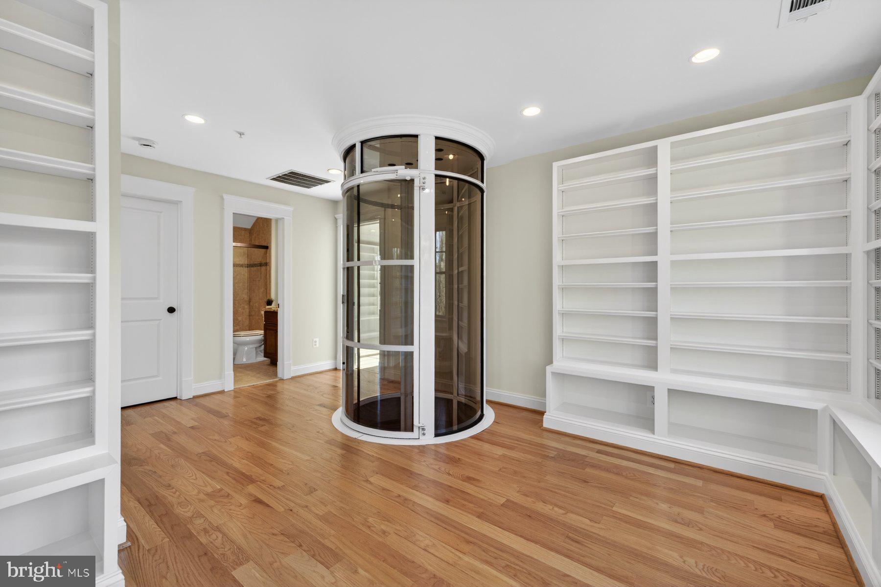 5011 Rugby Avenue Bethesda, MD 20814 - Photo 41 of 65 a view of a hallway with wooden shelves