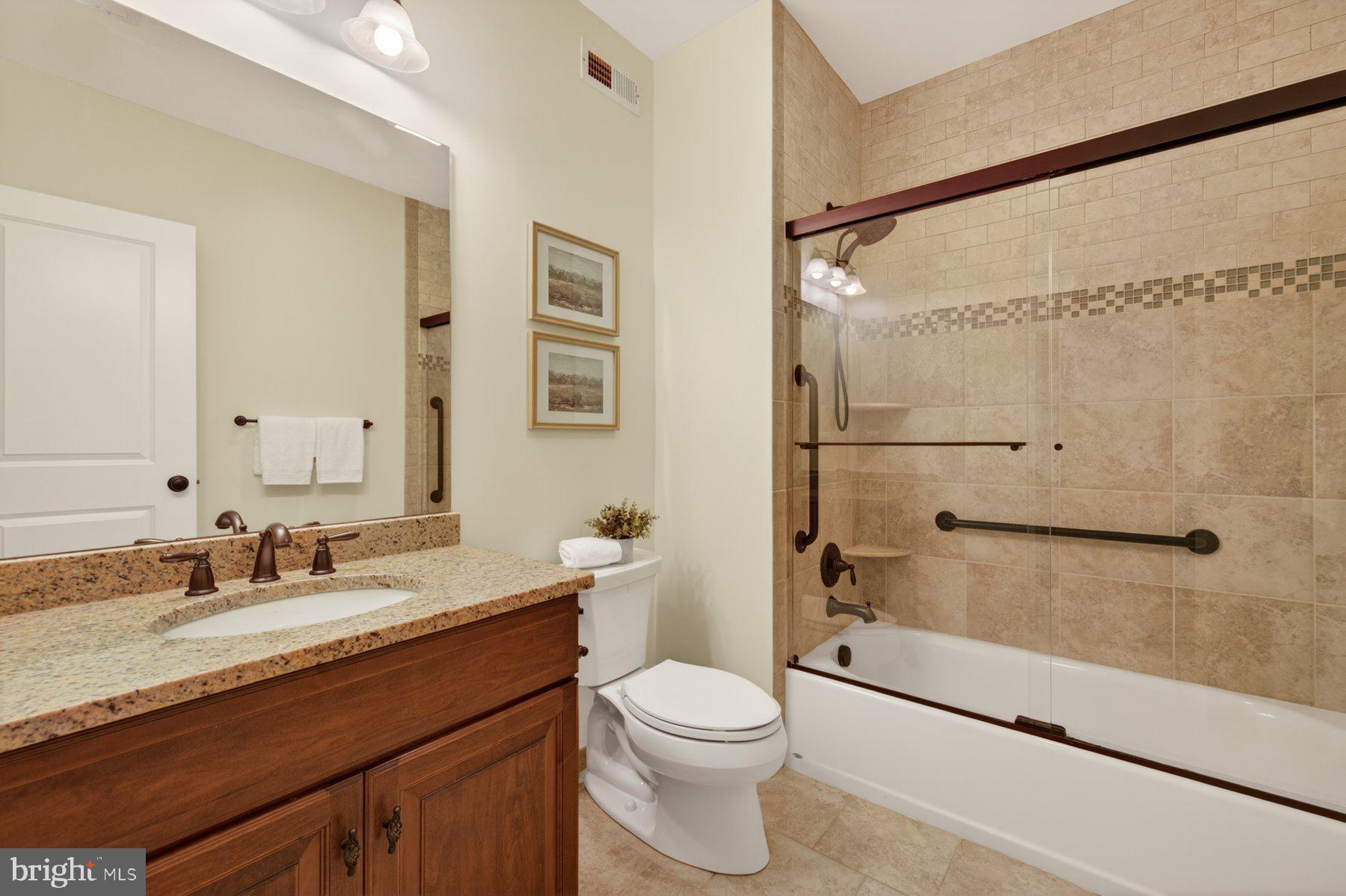 5011 Rugby Avenue Bethesda, MD 20814 - Photo 48 of 65 a bathroom with a granite countertop sink toilet and shower