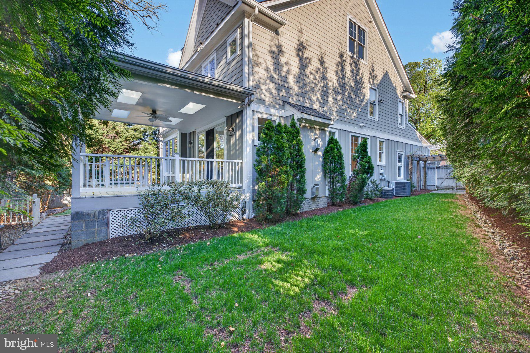 5011 Rugby Avenue Bethesda, MD 20814 - Photo 57 of 65 a view of a house with brick walls plants and large tree