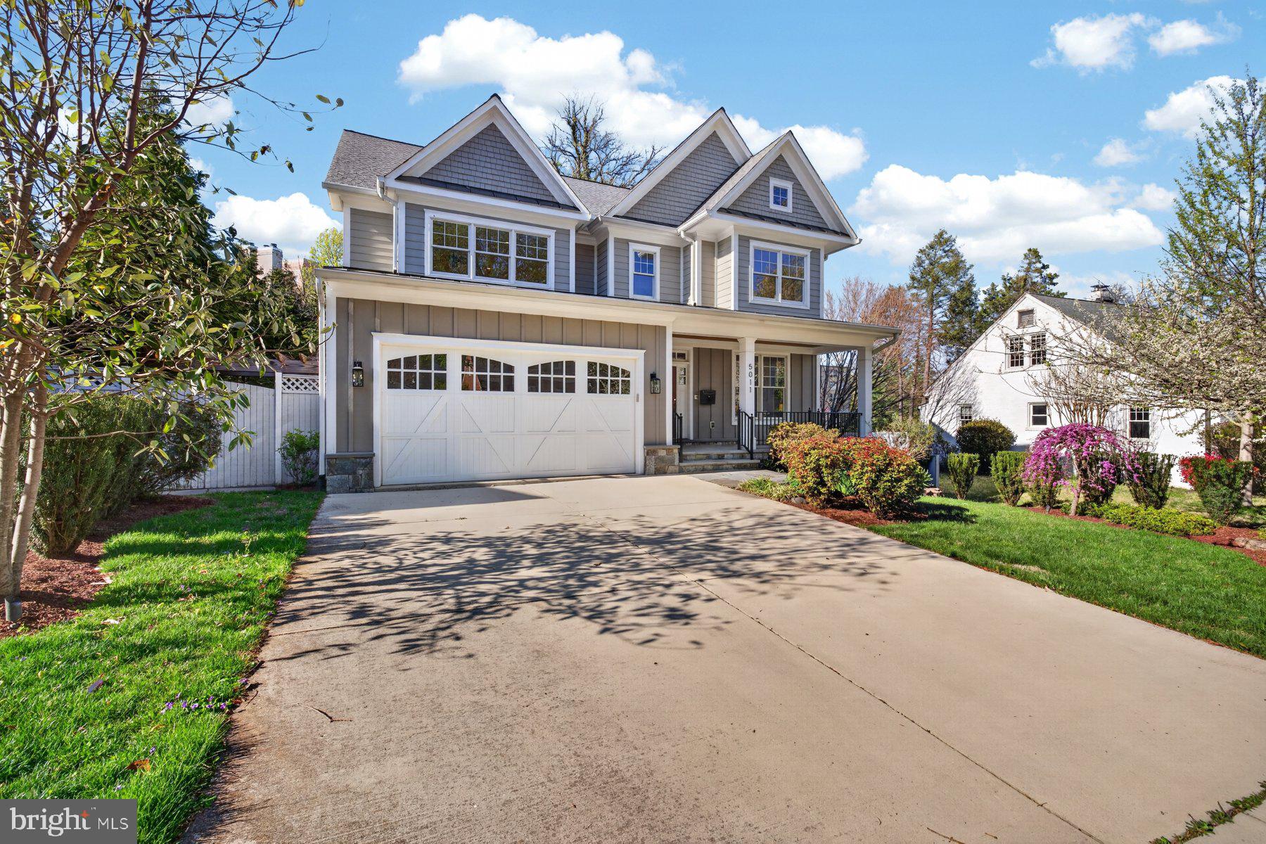 5011 Rugby Avenue Bethesda, MD 20814 - Photo 58 of 65 a front view of a house with a yard and garage