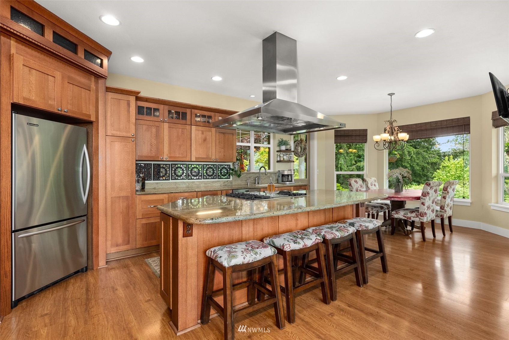 10434 Tilley Road Southwest Olympia, WA 98501 - Photo 15 of 40 a kitchen with stainless steel appliances granite countertop a table chairs and a refrigerator