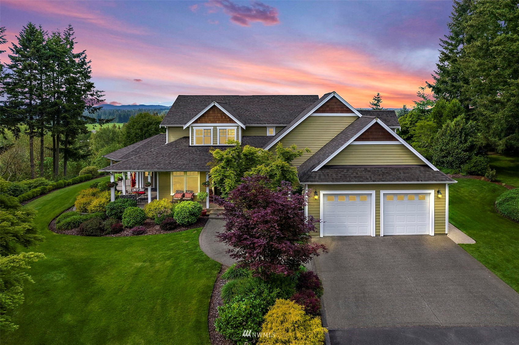 10434 Tilley Road Southwest Olympia, WA 98501 - Photo 2 of 40 a front view of a house with a yard and garage