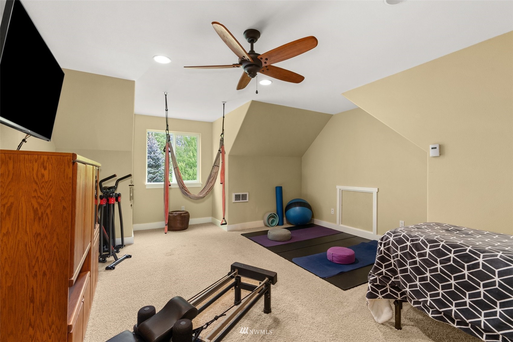 10434 Tilley Road Southwest Olympia, WA 98501 - Photo 24 of 40 a room with gym equipment and a flat screen tv