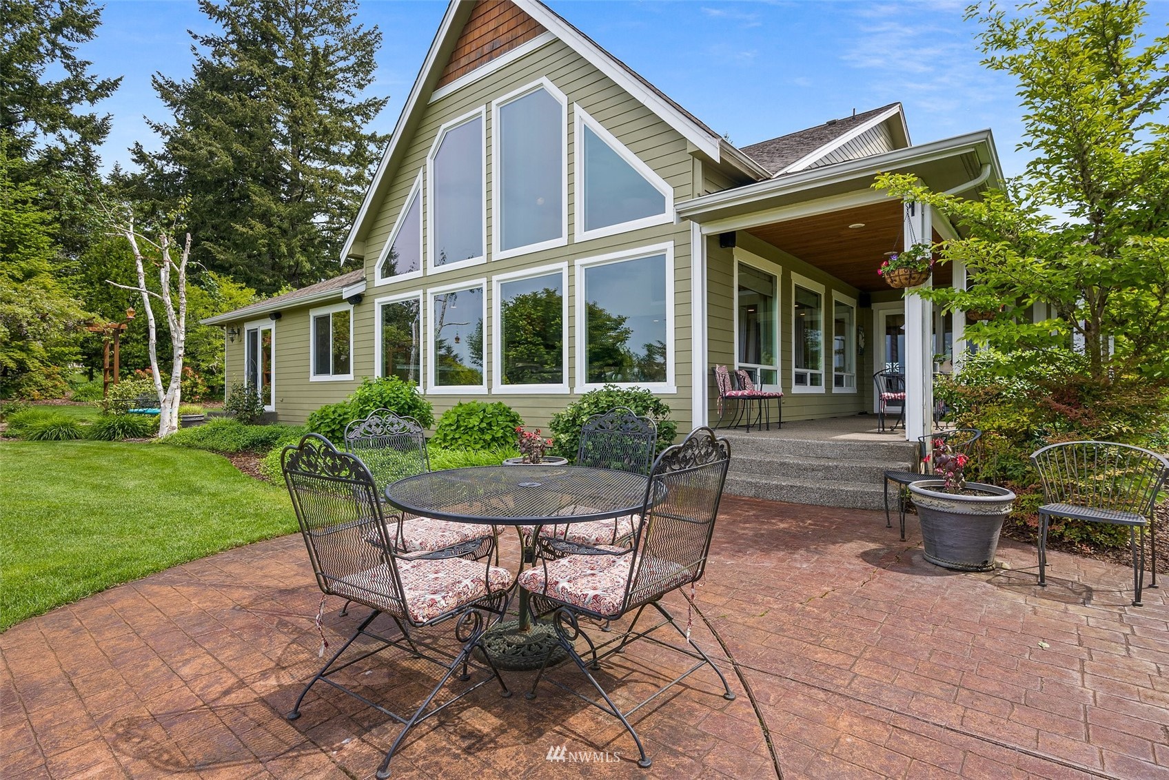10434 Tilley Road Southwest Olympia, WA 98501 - Photo 36 of 40 a view of a house with backyard sitting area and garden