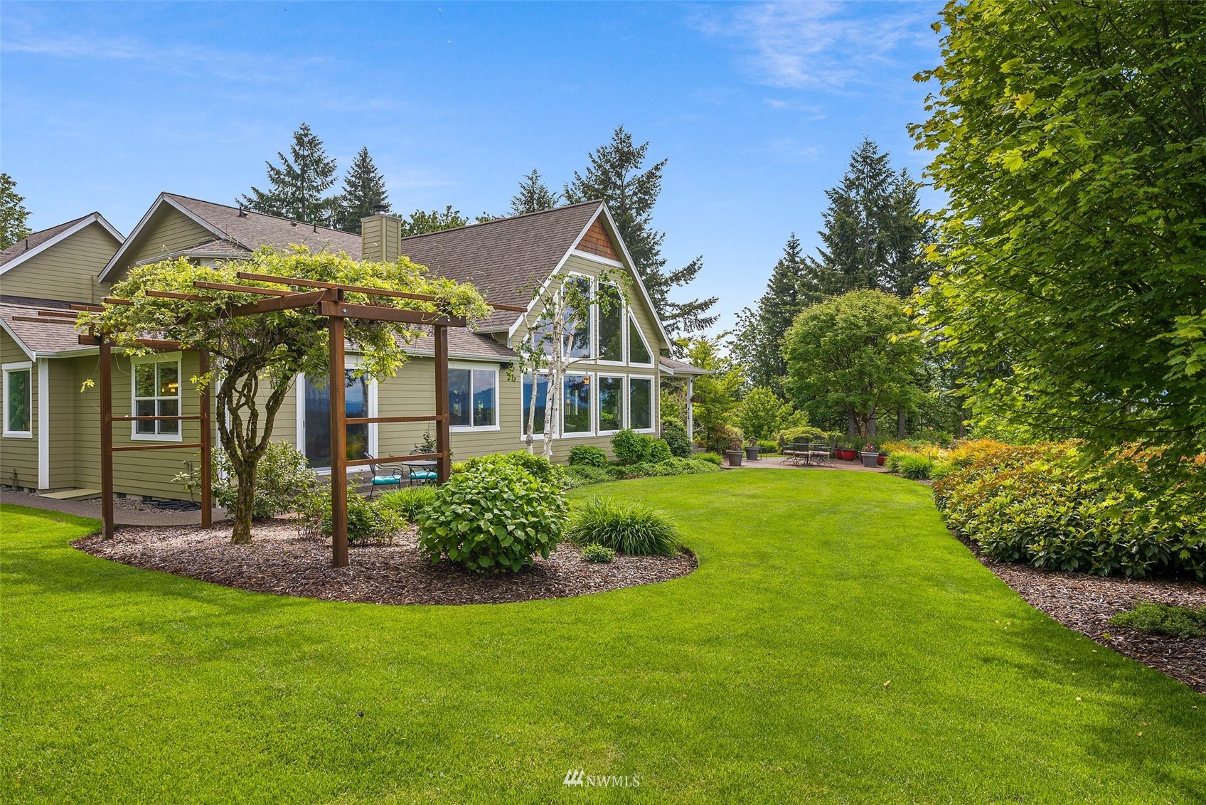 10434 Tilley Road Southwest Olympia, WA 98501 - Photo 37 of 40 a view of a big house with a big yard and large trees
