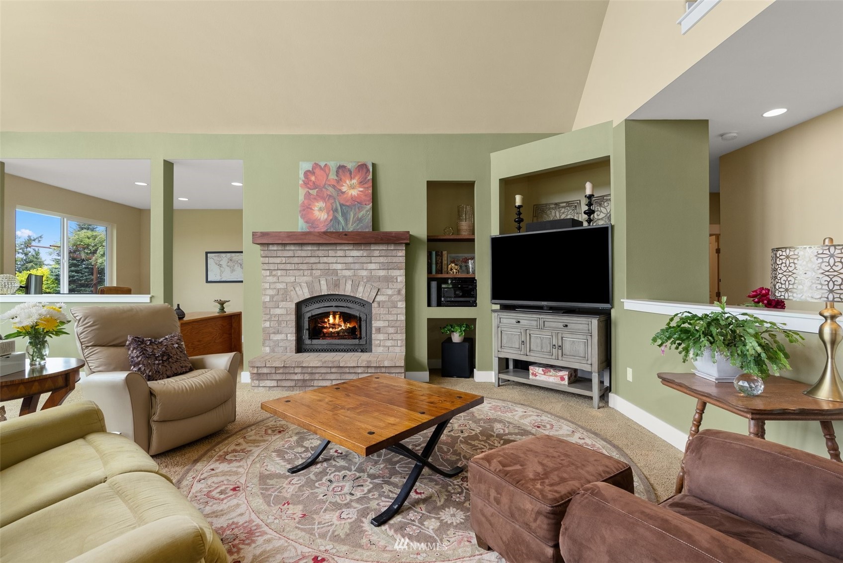 10434 Tilley Road Southwest Olympia, WA 98501 - Photo 10 of 40 a living room with furniture a flat screen tv and a fireplace