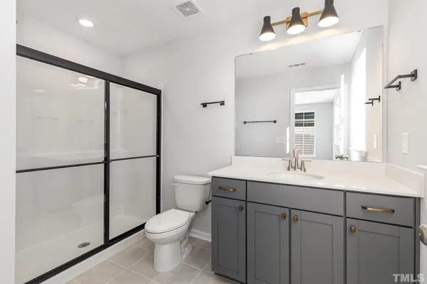 a bathroom with a toilet a sink and a mirror