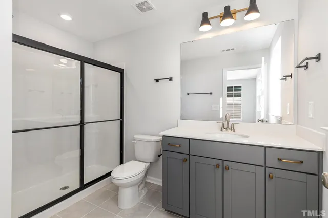 a bathroom with a toilet a sink and a mirror