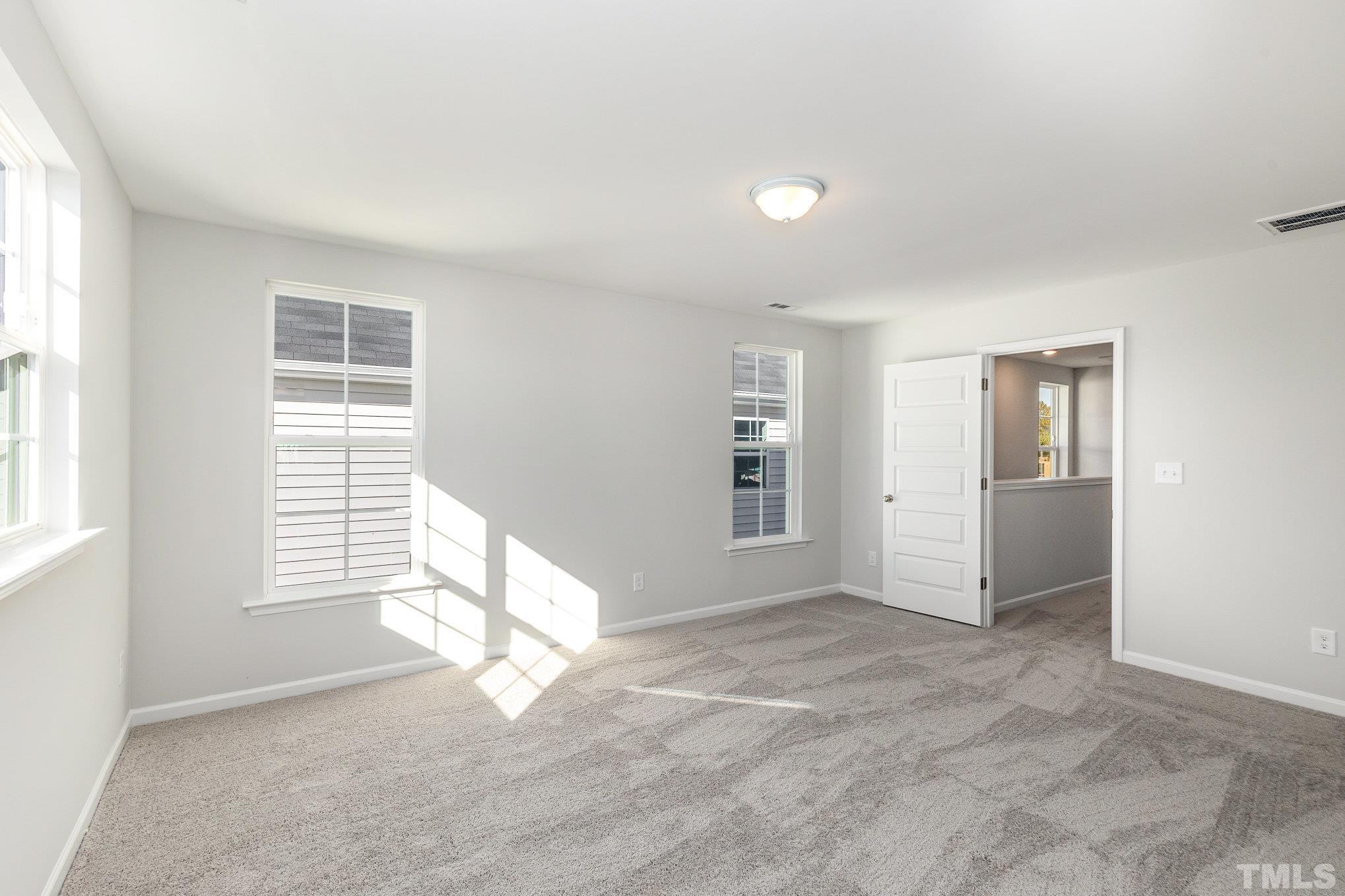 271 Pear Blossom Parkway Clayton, NC 27520 - Photo 16 of 25 an empty room with windows