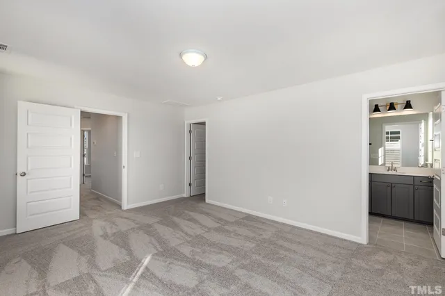 a view of an empty room with a kitchen