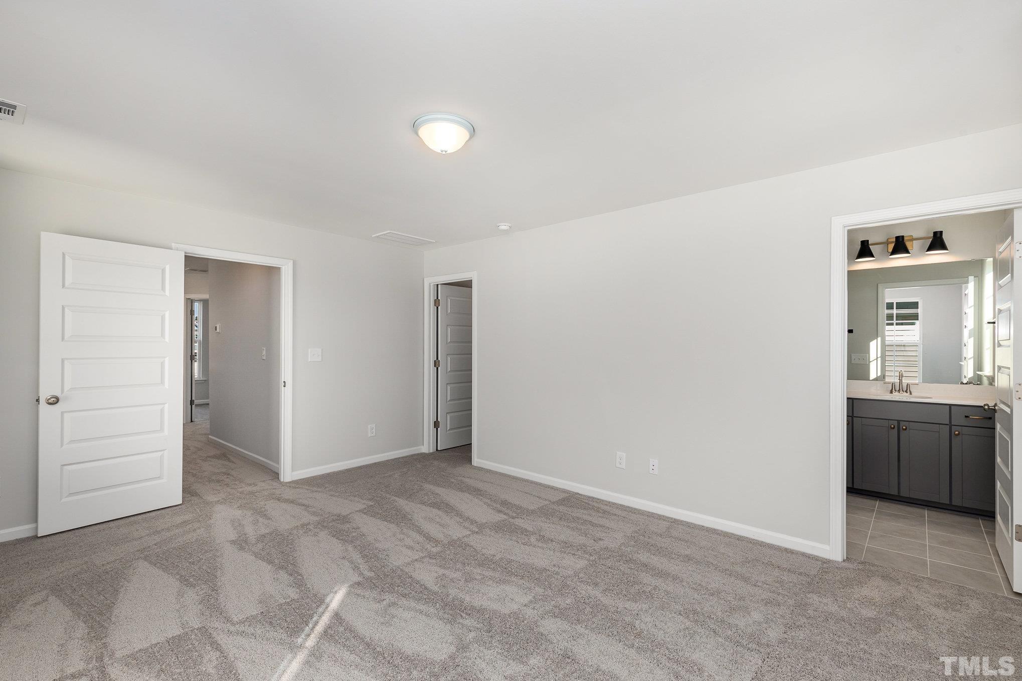 271 Pear Blossom Parkway Clayton, NC 27520 - Photo 17 of 25 a view of an empty room with a kitchen