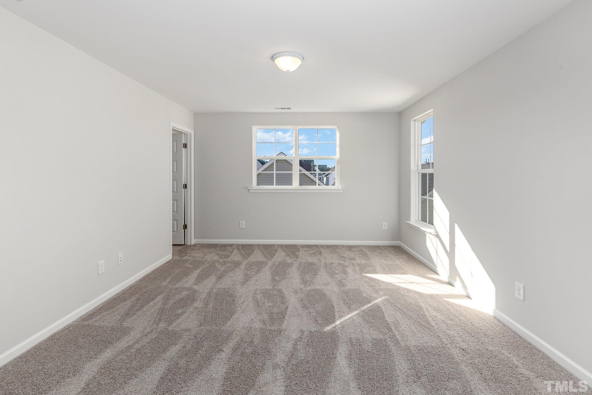 271 Pear Blossom Parkway Clayton, NC 27520 - Photo 18 of 25 an empty room with windows