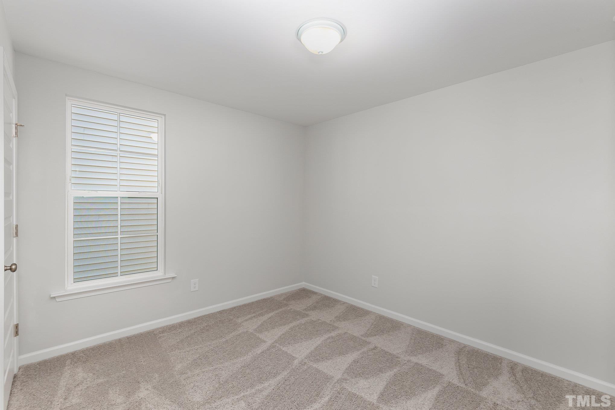 271 Pear Blossom Parkway Clayton, NC 27520 - Photo 19 of 25 an empty room with windows