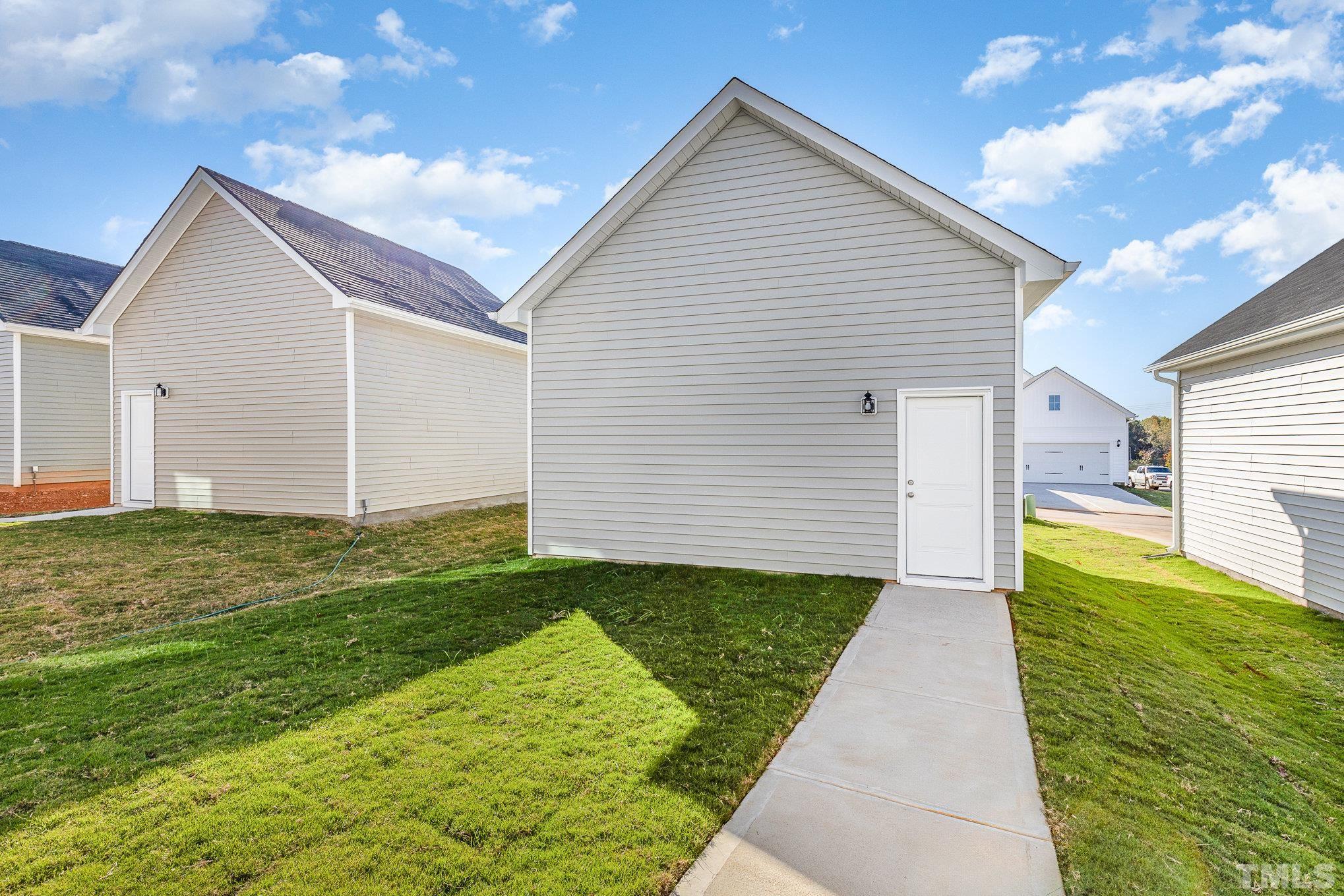 271 Pear Blossom Parkway Clayton, NC 27520 - Photo 22 of 25 a view of a backyard with potted plants