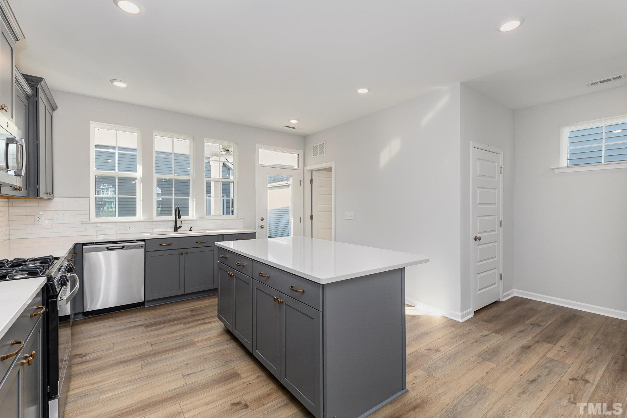 271 Pear Blossom Parkway Clayton, NC 27520 - Photo 10 of 25 a kitchen with sink stove and wooden floor