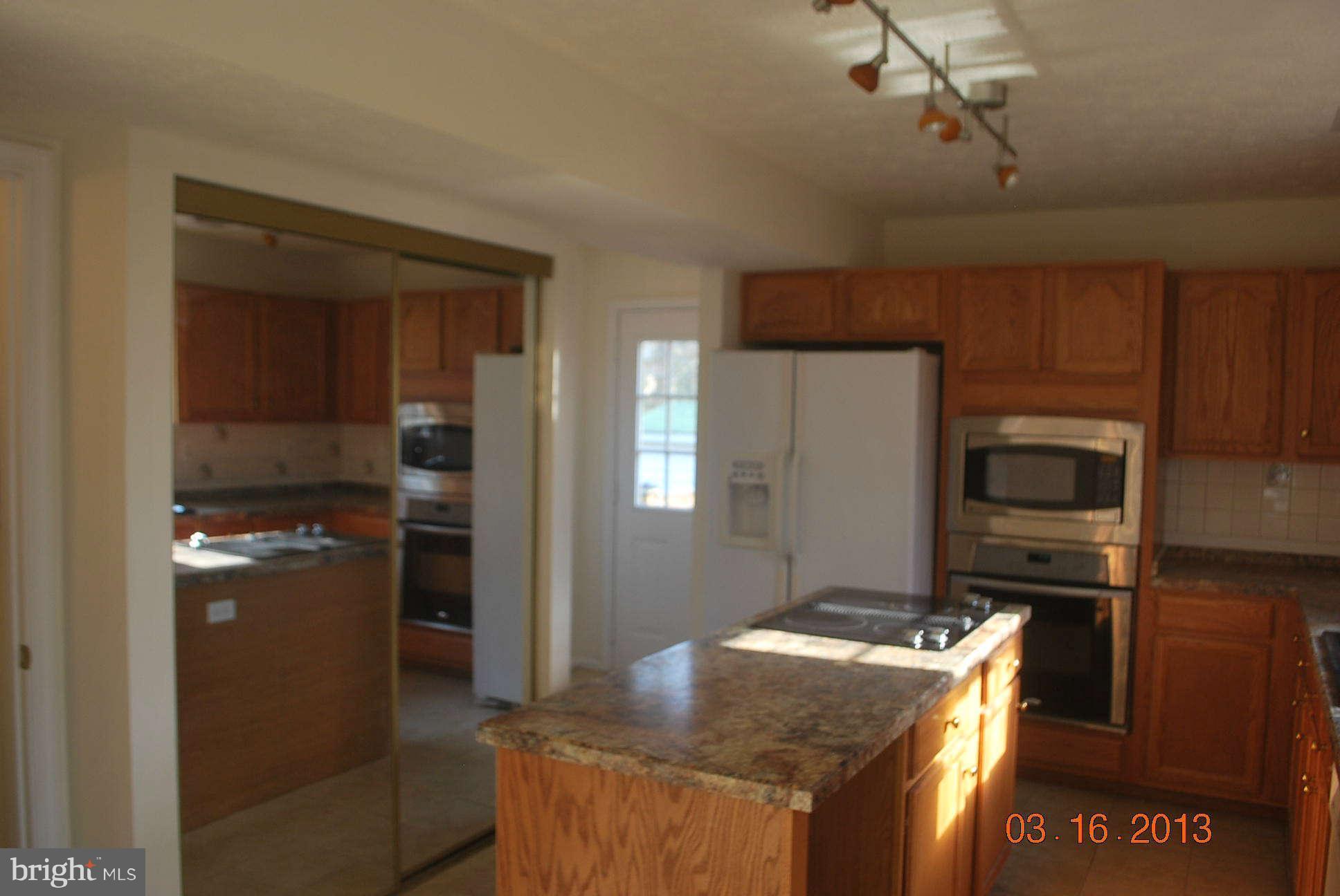 20161 Piney Point Road Callaway, MD 20620 - Photo 3 of 17 a kitchen with granite countertop a refrigerator stove and oven