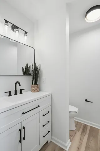 a bathroom with a sink a toilet and a mirror