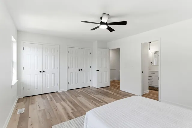 a big room with closet and wooden floor