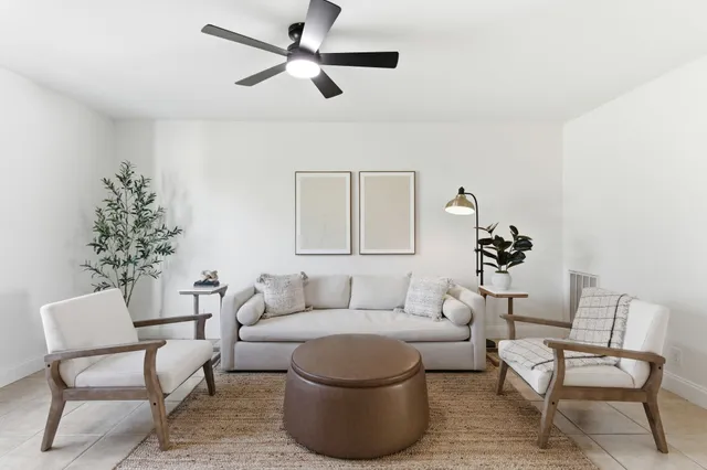 a living room with furniture and a chandelier
