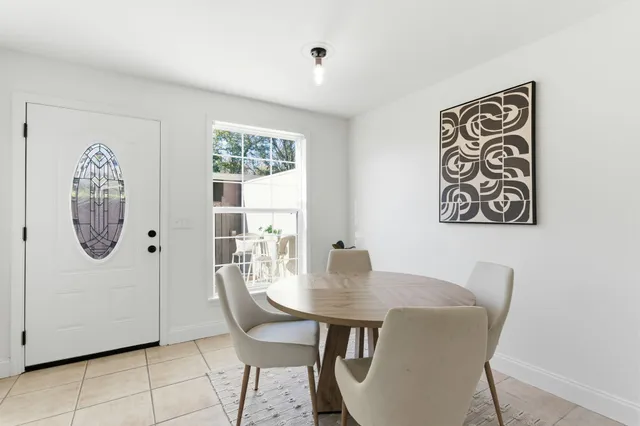 a view of a dining room with furniture and a window