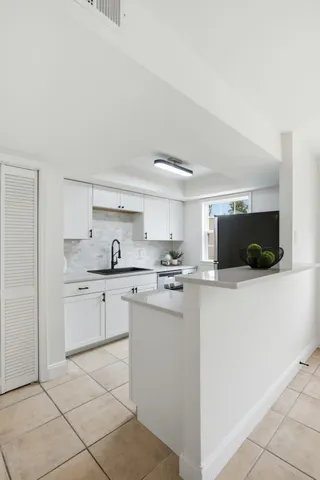 a kitchen with stainless steel appliances granite countertop a sink and a stove