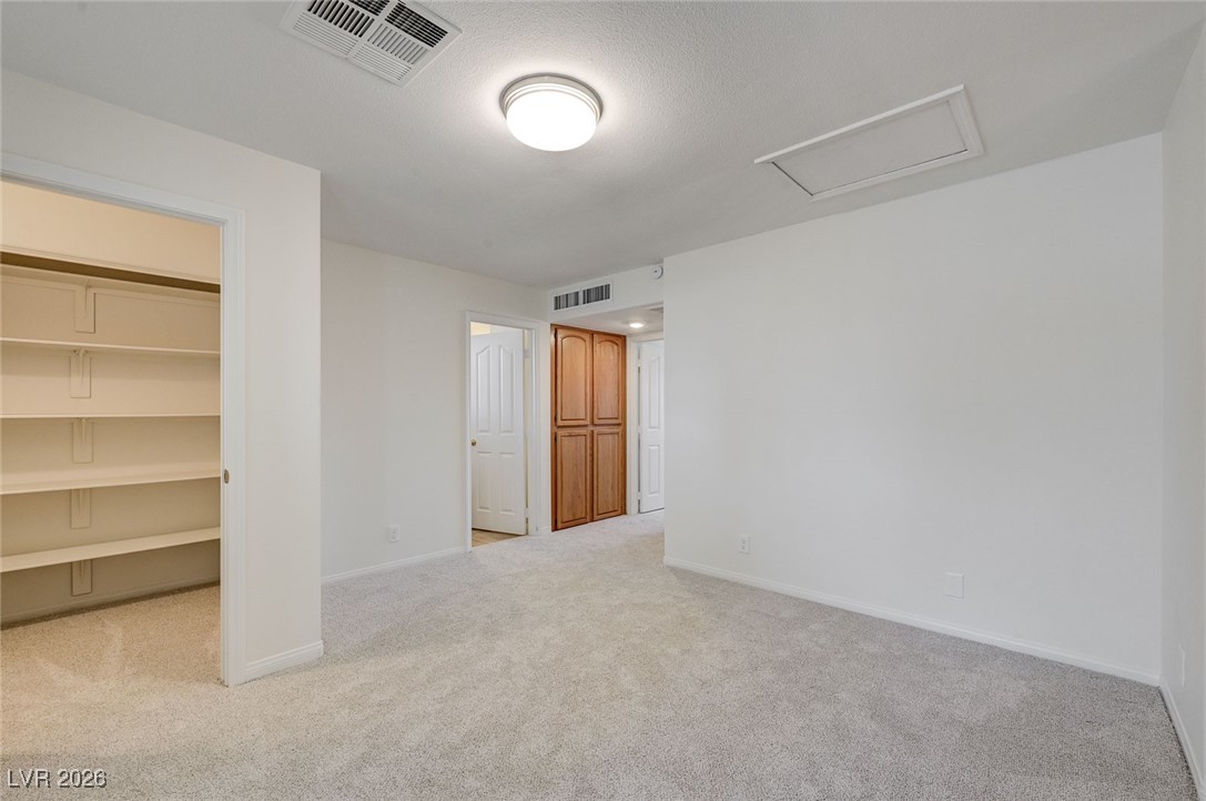 2955 El Camino Road Las Vegas, NV 89146 - Photo 64 of 99 Unfurnished room with attic access and light colored carpet