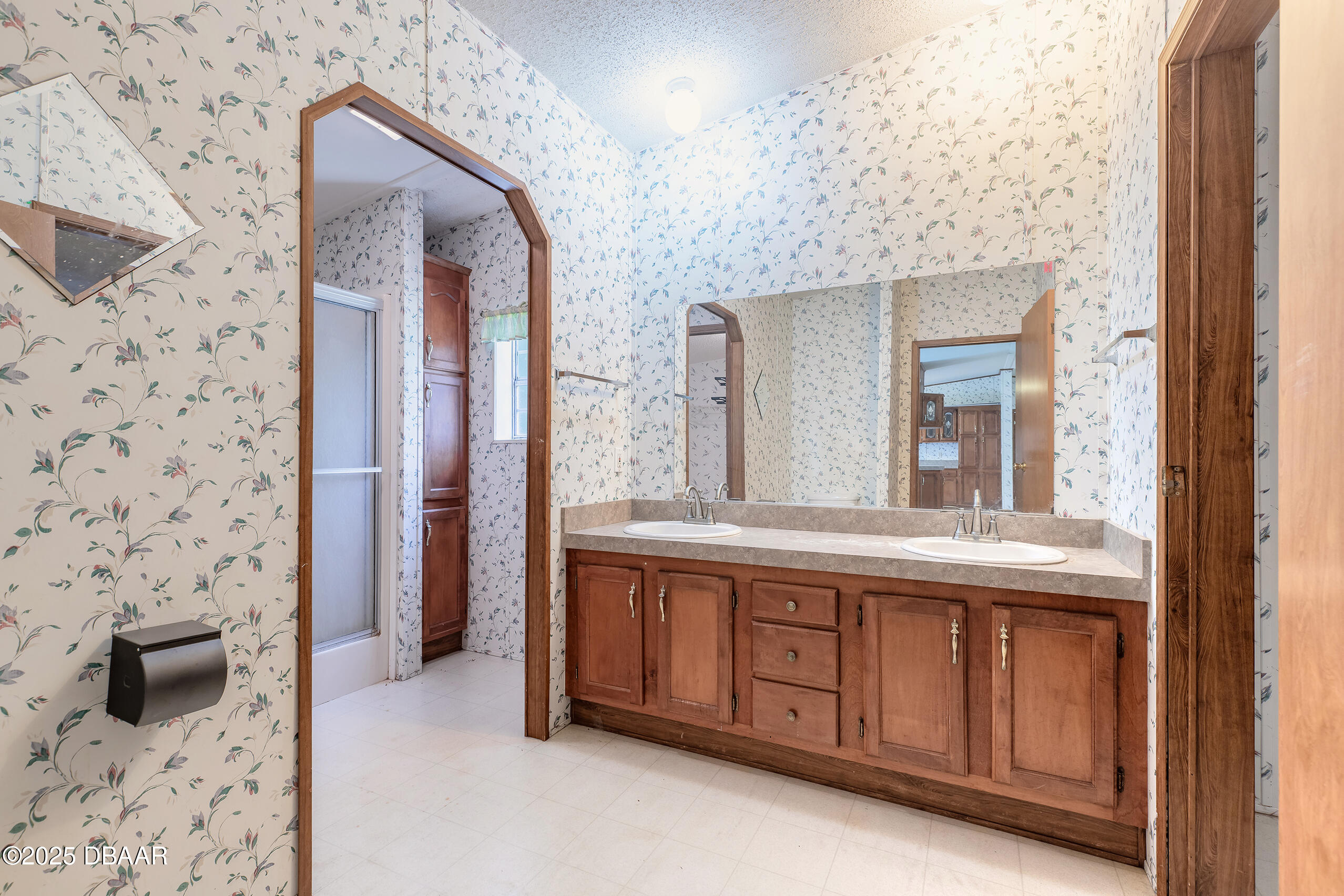 2127 Oak Street Bunnell, FL 32110 - Photo 16 of 48 a bathroom with a granite countertop sink and a mirror