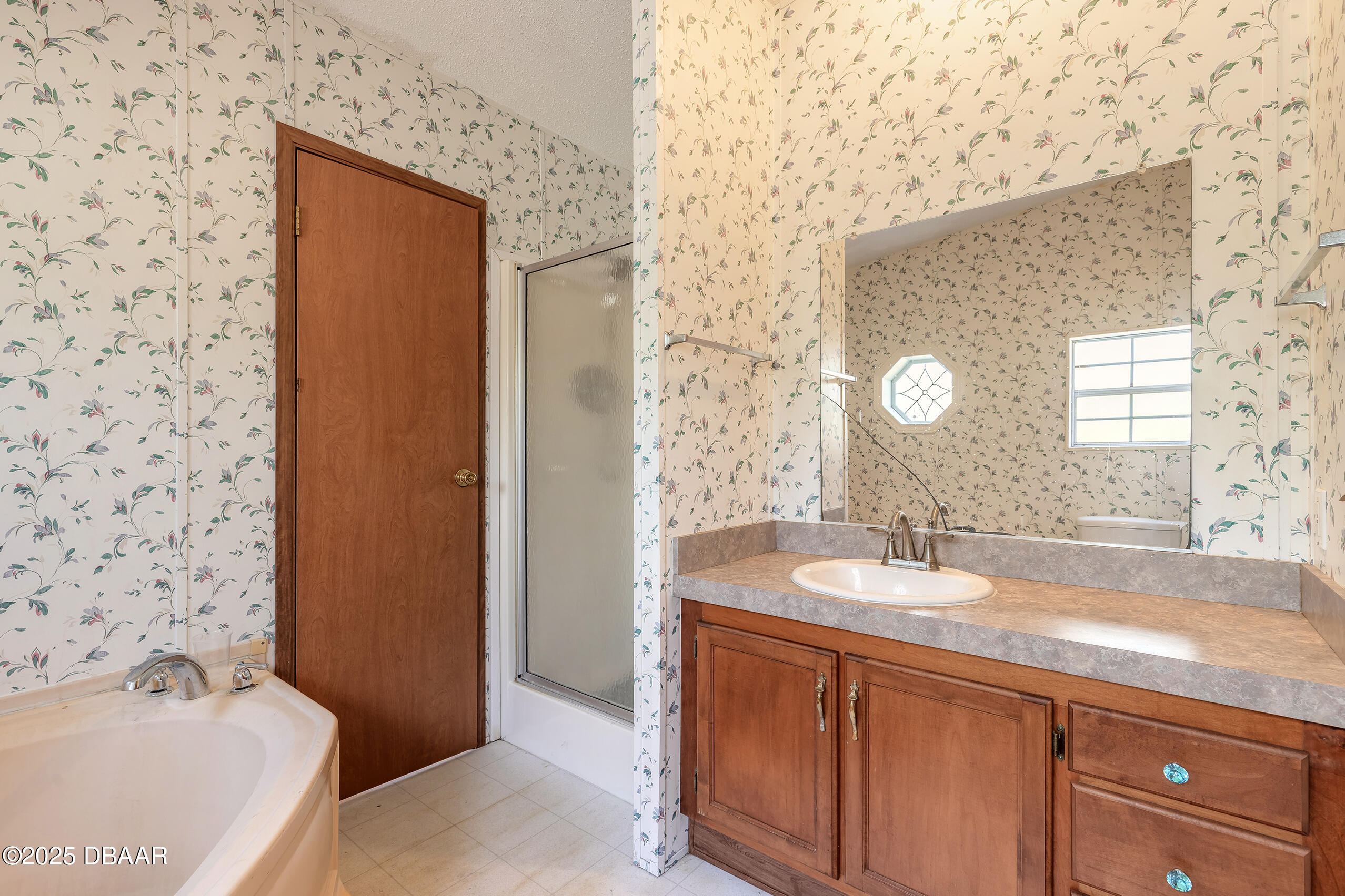 2127 Oak Street Bunnell, FL 32110 - Photo 22 of 48 a bathroom with a granite countertop sink and a mirror