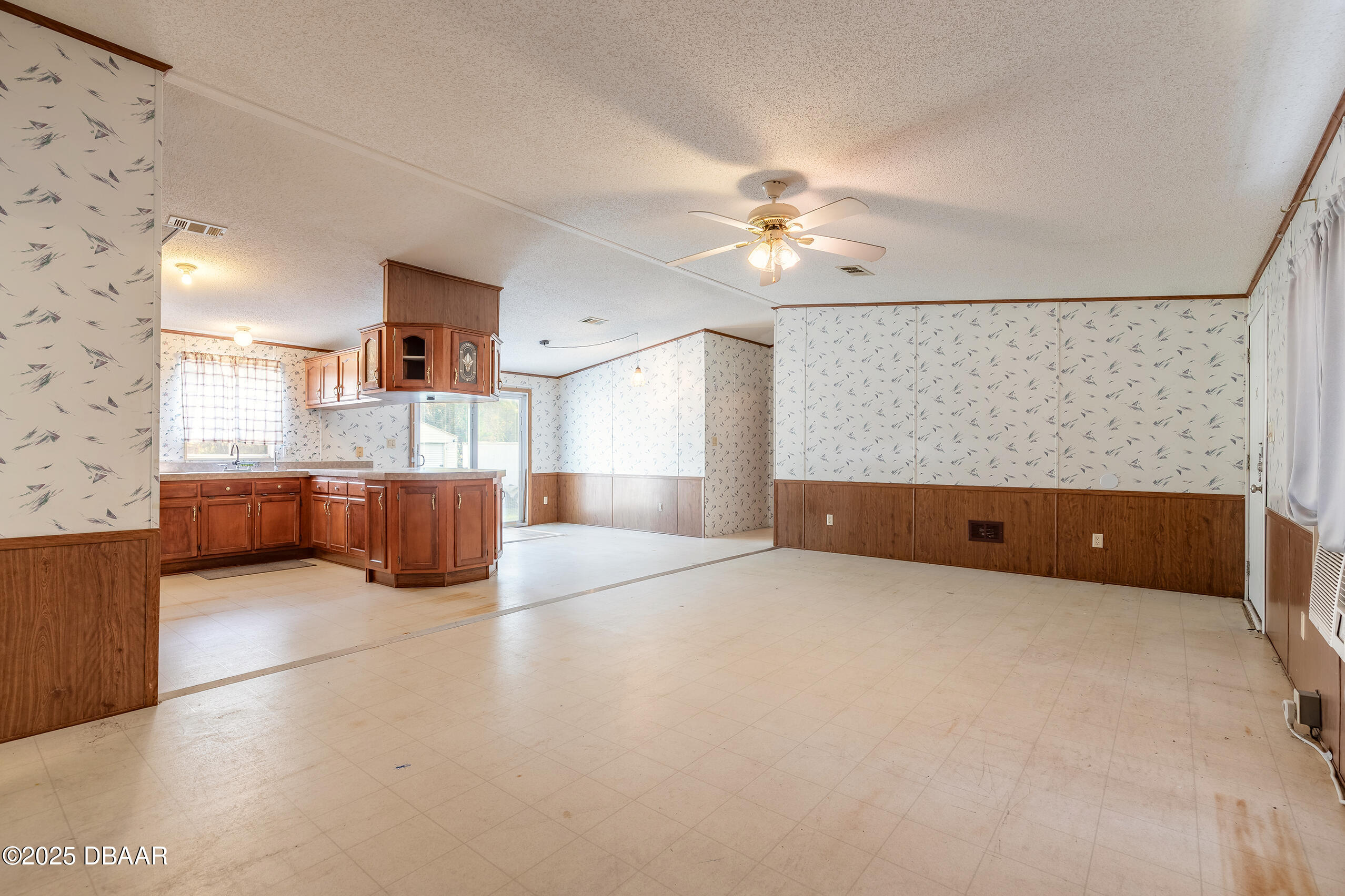 2127 Oak Street Bunnell, FL 32110 - Photo 24 of 48 a living room with furniture and a chandelier