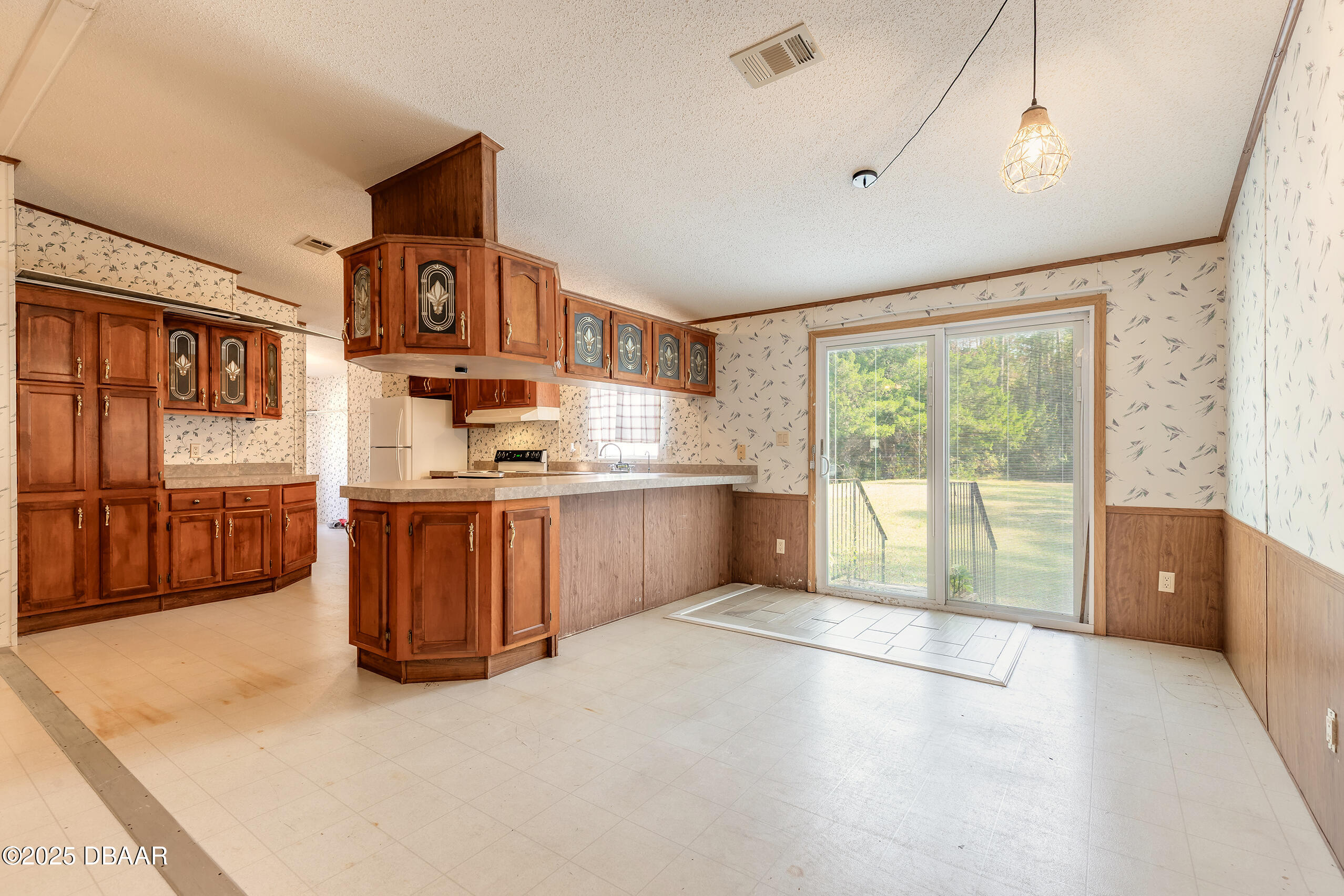 2127 Oak Street Bunnell, FL 32110 - Photo 26 of 48 a kitchen with stainless steel appliances granite countertop a stove a sink and a refrigerator with cabinets