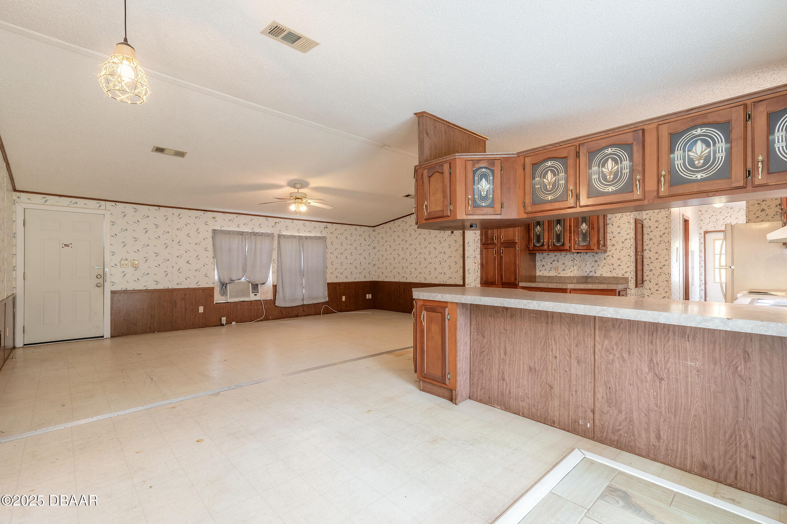 2127 Oak Street Bunnell, FL 32110 - Photo 27 of 48 a view of a kitchen with kitchen island a stove a microwave and a view of living room