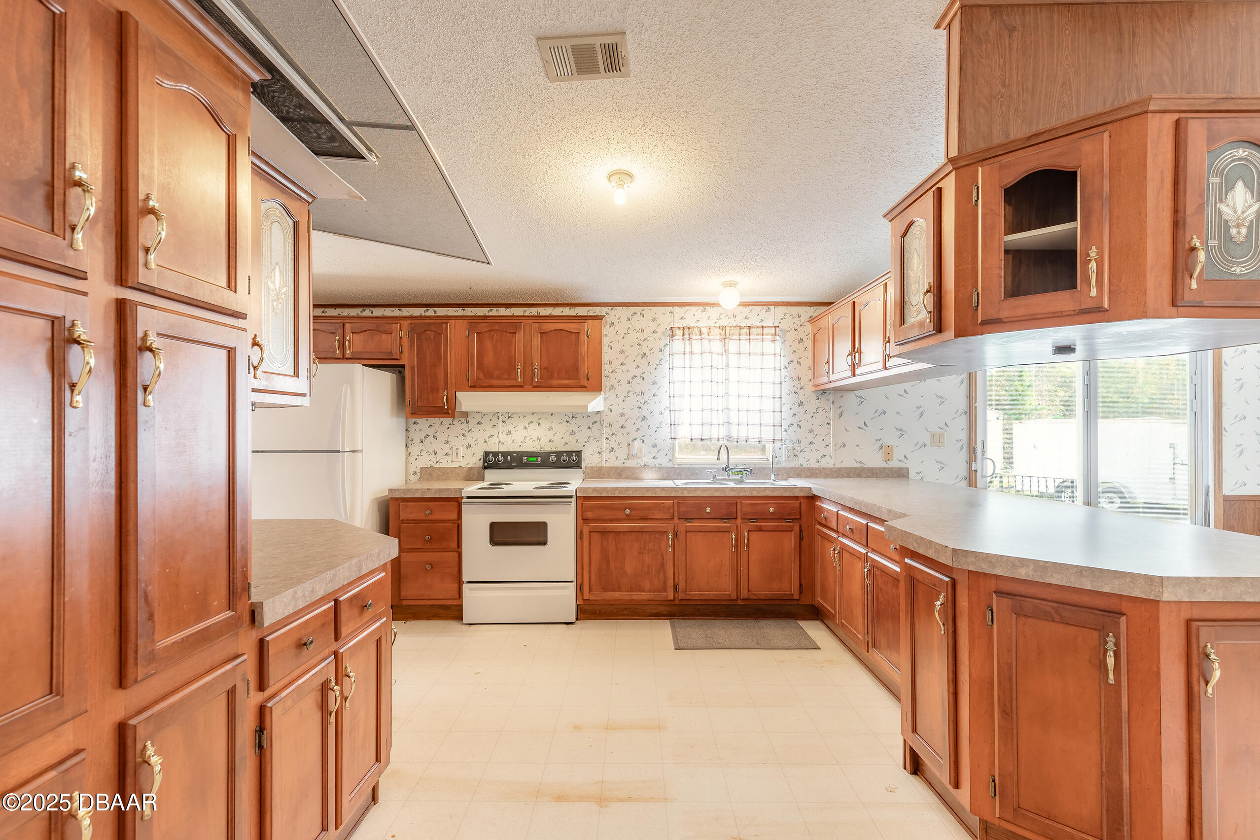 2127 Oak Street Bunnell, FL 32110 - Photo 29 of 48 a kitchen with stainless steel appliances granite countertop a sink and cabinets