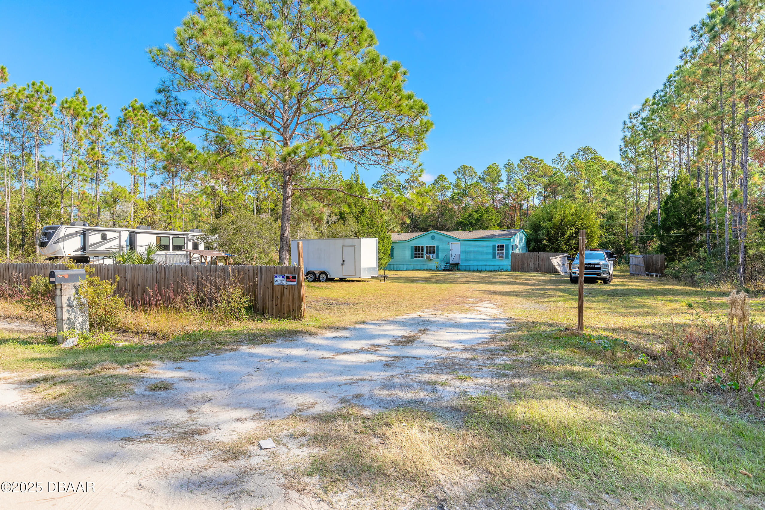 2127 Oak Street Bunnell, FL 32110 - Photo 3 of 48 a swimming pool with trees in the background