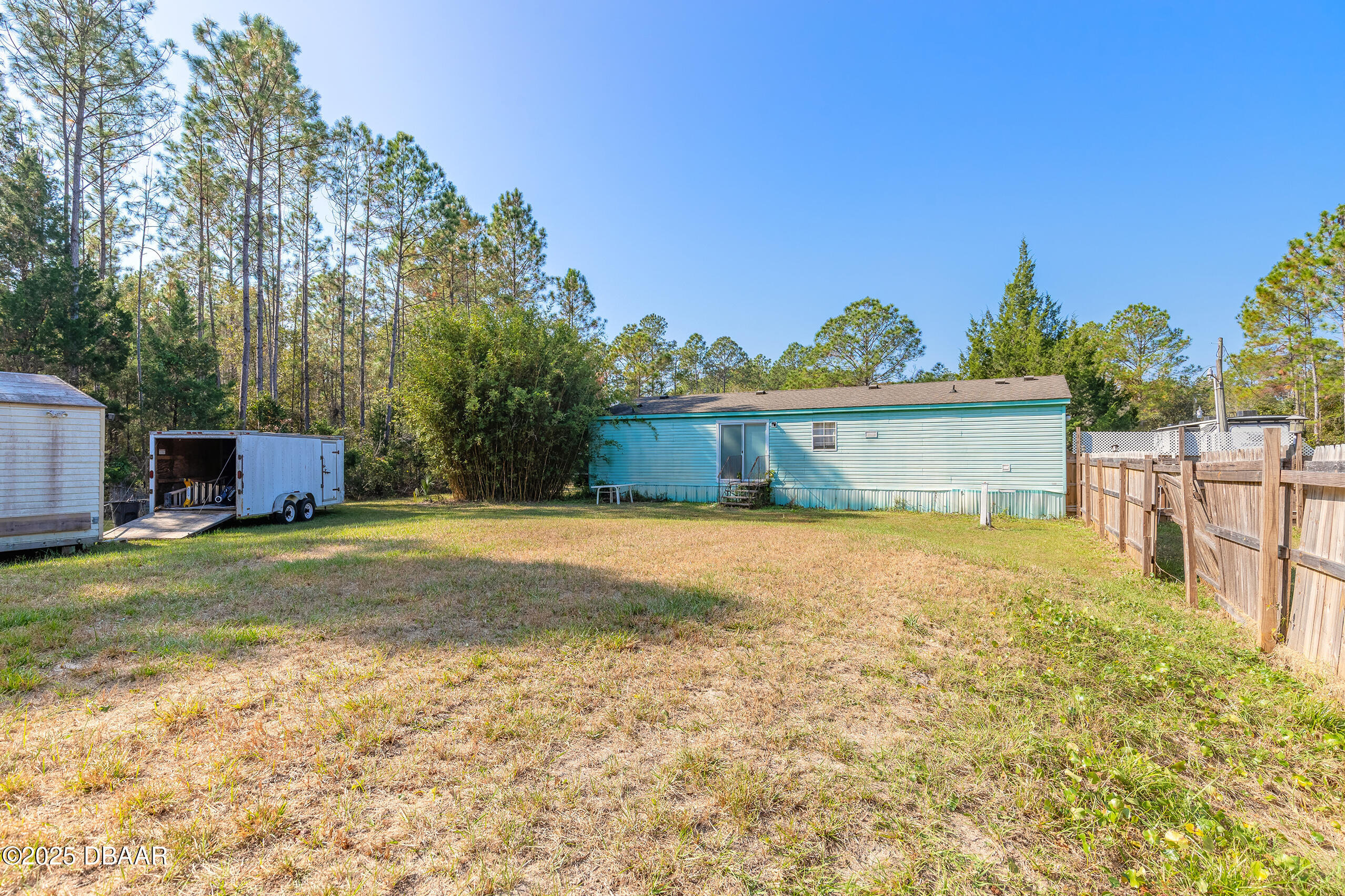 2127 Oak Street Bunnell, FL 32110 - Photo 10 of 48 a front view of house with yard and trees in the background
