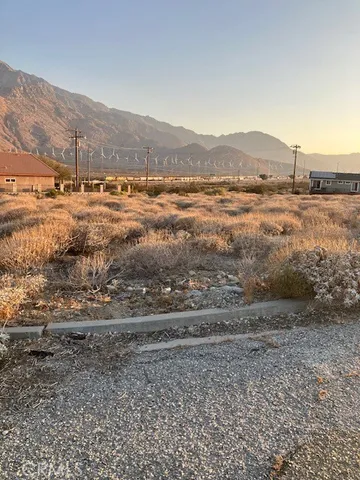 a view of a street with mountains in the background