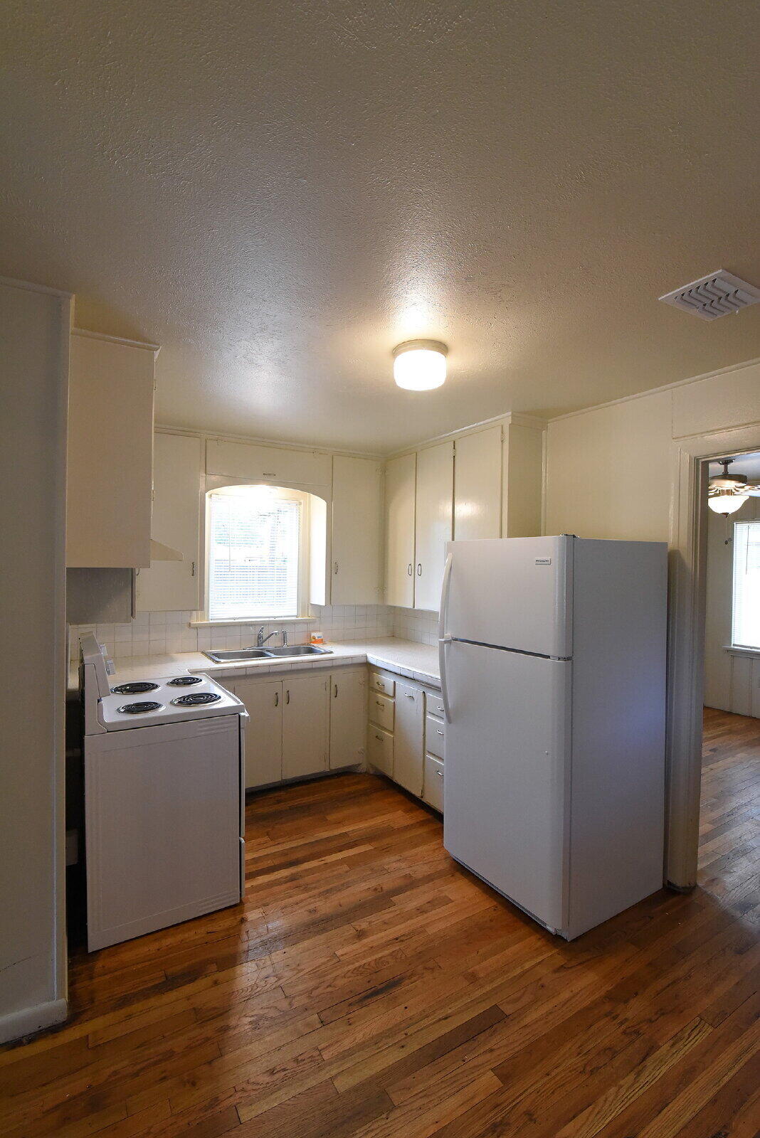 2006 29th Street, Unit FRONT Lubbock, TX 79411 - Photo 4 of 8 a kitchen with a cabinets and wooden floor