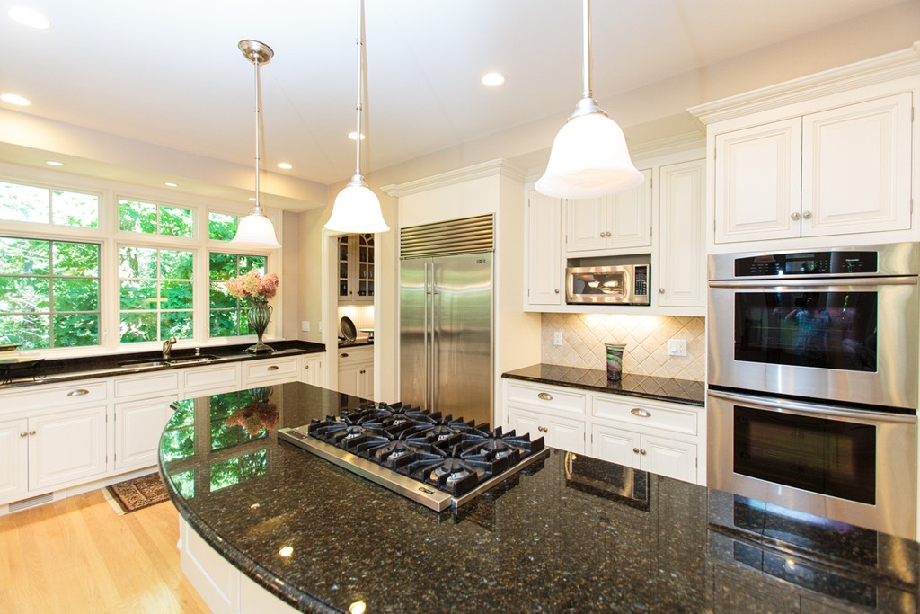 24 Sabrina Road Wellesley, MA 02482 - Photo 9 of 21 a kitchen with stainless steel appliances granite countertop a stove a sink and a wooden floors