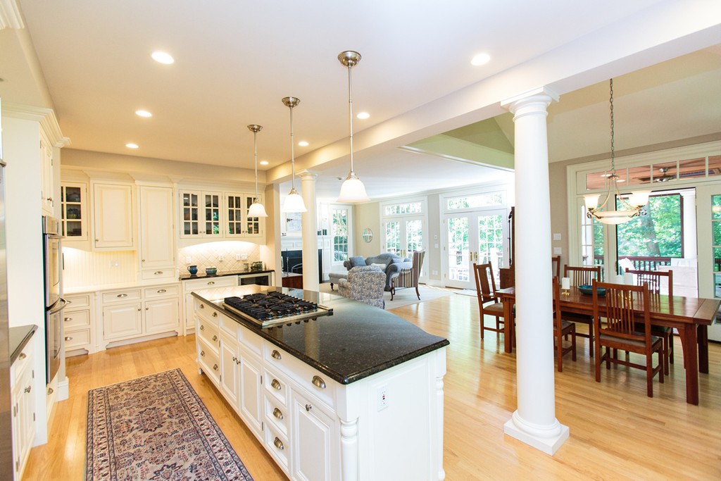 24 Sabrina Road Wellesley, MA 02482 - Photo 10 of 21 a kitchen with stainless steel appliances kitchen island granite countertop a stove a sink a refrigerator and white cabinets with wooden floor