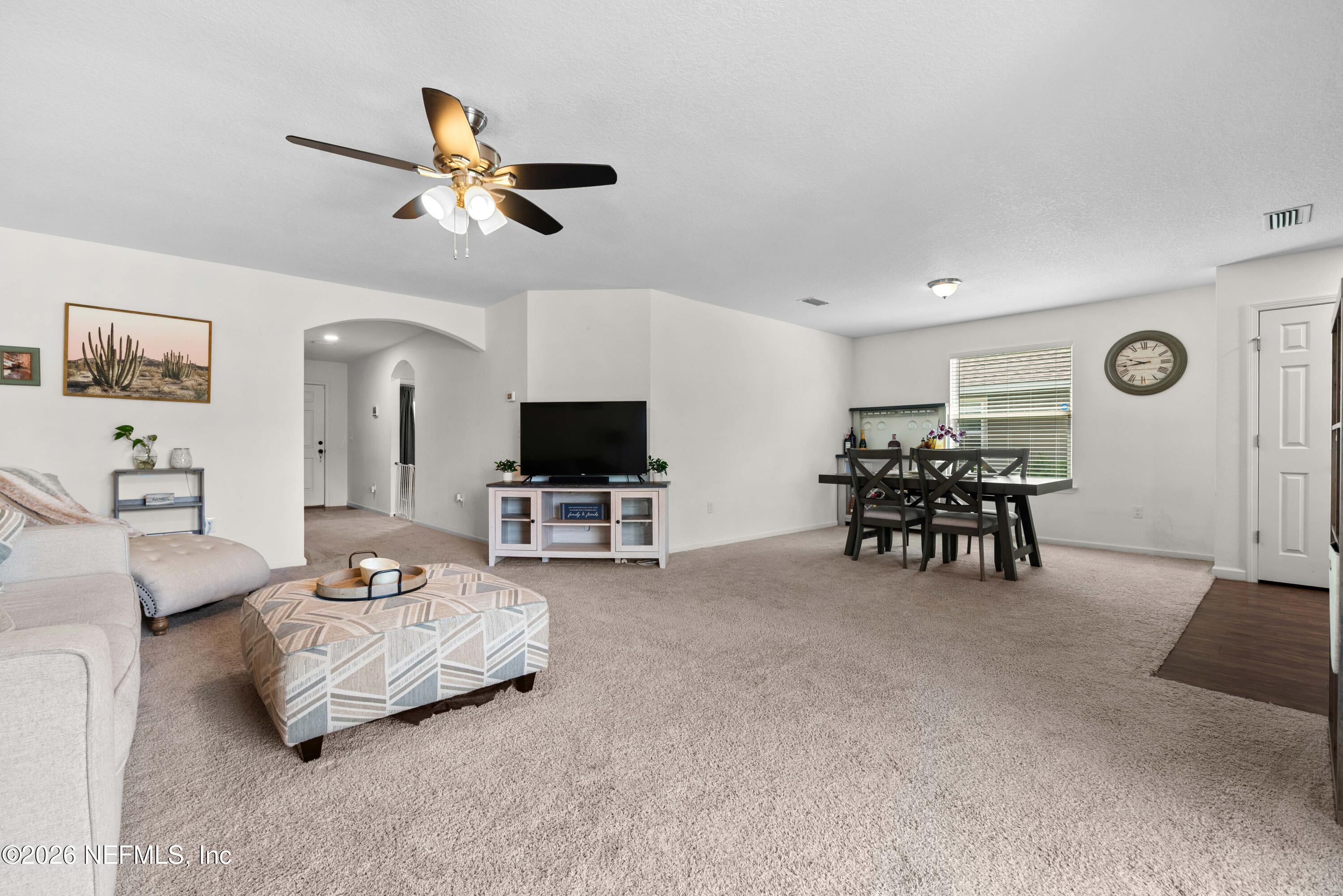 6178 Daylilly Road Macclenny, FL 32063 - Photo 6 of 29 a living room with furniture and a flat screen tv