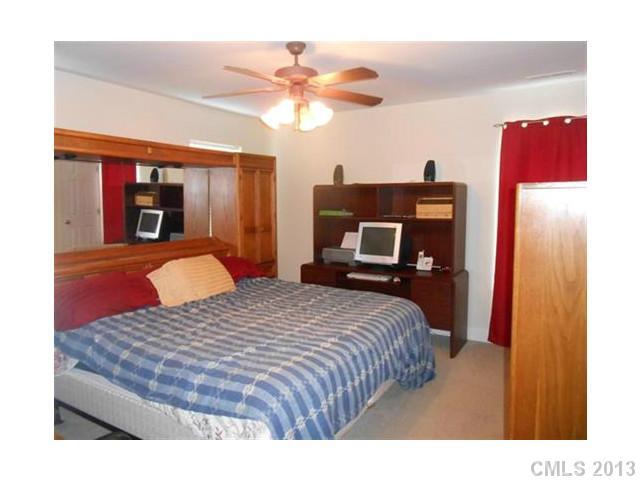 3671 East North Corner Road Lancaster, SC 29720 - Photo 9 of 16 a bedroom with a bed and a chandelier