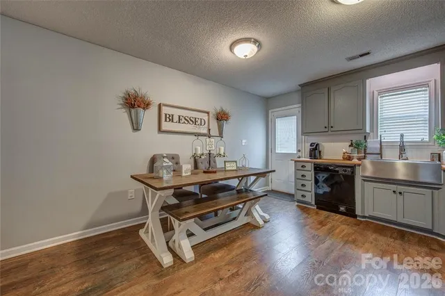 a view of a workspace with furniture and wooden floor