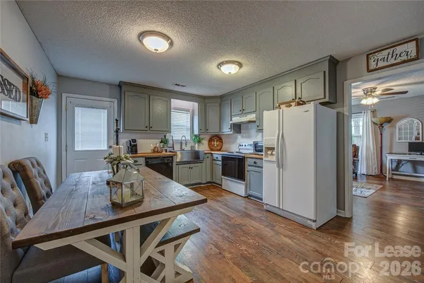 a kitchen with refrigerator cabinets dining table and chairs
