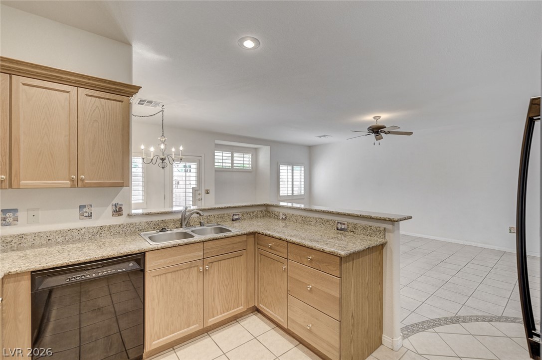 1479 Orange Jubilee Road Henderson, NV 89014 - Photo 13 of 36 A well-appointed kitchen features ample counter space and an open view to the living area.